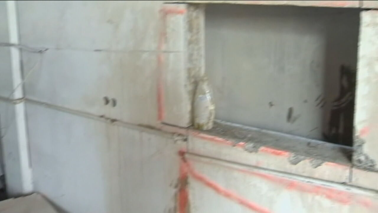 Naked woman stuck between walls